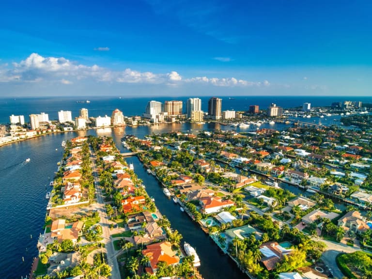 Aerial view of Fort Lauderdale's waterfront isles along the Intracoastal Waterway, with the beach skyline beyond